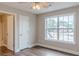 Bedroom featuring hardwood floors, a large window and entrance to the bathroom at 190 Holcomb Ct, Fayetteville, GA 30215