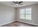 Bedroom with hardwood floors, fan, and natural light from the large window at 190 Holcomb Ct, Fayetteville, GA 30215