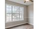 Bedroom features a large window, hardwood floors, a ceiling fan, and natural-colored walls at 190 Holcomb Ct, Fayetteville, GA 30215