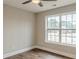 Bedroom featuring a large window, ceiling fan and beautiful hardwood floors at 190 Holcomb Ct, Fayetteville, GA 30215