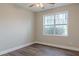 This Bedroom features hardwood floors, neutral colored walls, a ceiling fan, and a window at 190 Holcomb Ct, Fayetteville, GA 30215