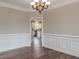 Dining room featuring light-colored walls, wood floors, and a doorway to the kitchen at 190 Holcomb Ct, Fayetteville, GA 30215