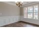 Dining room features hardwood floors, a modern light fixture, and a large window providing natural light at 190 Holcomb Ct, Fayetteville, GA 30215