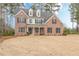 Charming two-story brick home with black shutters, dormer windows, and a spacious front lawn at 190 Holcomb Ct, Fayetteville, GA 30215