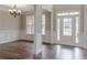 Welcoming foyer with wood floors, high ceilings, and elegant trim, leading into the dining room at 190 Holcomb Ct, Fayetteville, GA 30215