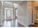 Spacious foyer featuring wood floors, wainscoting, and access to a nearby bathroom at 190 Holcomb Ct, Fayetteville, GA 30215