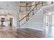 Spacious foyer with staircase, wood floors and view to the kitchen at 190 Holcomb Ct, Fayetteville, GA 30215