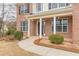 Inviting front entrance features brick facade, columns, and a well-maintained walkway and manicured bushes at 190 Holcomb Ct, Fayetteville, GA 30215