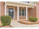 Charming brick home featuring a covered front porch with white columns and a stylish black front door at 190 Holcomb Ct, Fayetteville, GA 30215