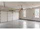 Spacious two car garage featuring a light gray epoxy floor and bright natural light from side windows at 190 Holcomb Ct, Fayetteville, GA 30215