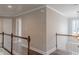 Hallway with wood floors, white railings, and neutral walls at 190 Holcomb Ct, Fayetteville, GA 30215