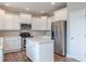 Kitchen showcasing white cabinets, stainless steel appliances, and an island at 190 Holcomb Ct, Fayetteville, GA 30215