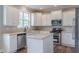 Kitchen showcasing white cabinets, stainless steel appliances, and a center island at 190 Holcomb Ct, Fayetteville, GA 30215