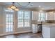 Eat-in kitchen featuring white cabinets, stainless steel appliances, and backyard views at 190 Holcomb Ct, Fayetteville, GA 30215