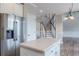 Open kitchen featuring white cabinets, stainless steel appliances, and a view of the staircase at 190 Holcomb Ct, Fayetteville, GA 30215