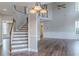 Bright living room features wood floors, staircase, and a ceiling fan at 190 Holcomb Ct, Fayetteville, GA 30215