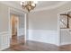 Living Room showcasing light-colored walls, hardwood flooring, and doorways to other rooms at 190 Holcomb Ct, Fayetteville, GA 30215