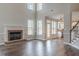 Spacious living room featuring a fireplace, large windows and hardwood floors at 190 Holcomb Ct, Fayetteville, GA 30215