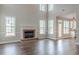 Bright living room featuring a brick fireplace, large windows, and modern wood floors at 190 Holcomb Ct, Fayetteville, GA 30215