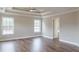 Spacious main bedroom featuring hardwood floors, coffered ceiling and entrance to the bathroom at 190 Holcomb Ct, Fayetteville, GA 30215