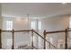 Second story staircase with white banisters and hardwood floors at 190 Holcomb Ct, Fayetteville, GA 30215