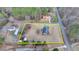 High aerial shows large lot with house and outbuildings outlined in yellow. Bordered by road and mature trees at 2111 Jade Dr, Canton, GA 30115