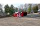 This backyard features a red shed and storage building with a large yard and privacy fence at 2111 Jade Dr, Canton, GA 30115