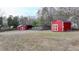 Expansive backyard features two red sheds with white trim offering ample storage space at 2111 Jade Dr, Canton, GA 30115