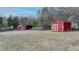 Expansive backyard features two red sheds with white trim offering ample storage space at 2111 Jade Dr, Canton, GA 30115