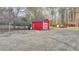 Large backyard featuring a bright red shed with white trim and a view of the lawn at 2111 Jade Dr, Canton, GA 30115