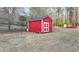 Large backyard featuring a bright red shed with white trim and a view of the lawn at 2111 Jade Dr, Canton, GA 30115