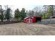 This backyard features a red shed and storage building with a large yard and privacy fence at 2111 Jade Dr, Canton, GA 30115