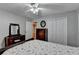 Bedroom showcasing a dresser with mirror, hardwood floors, and double door closet at 2111 Jade Dr, Canton, GA 30115