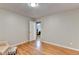 Bright bedroom showcasing hardwood floors and an open doorway leading to another room at 2111 Jade Dr, Canton, GA 30115