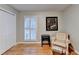 Cozy bedroom featuring hardwood floors, a window with shutters, and a comfortable chair with ottoman at 2111 Jade Dr, Canton, GA 30115