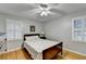 Inviting bedroom with a ceiling fan, wood floors, and a window with shutters at 2111 Jade Dr, Canton, GA 30115