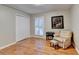 Inviting bedroom with hardwood floors, a neutral color palette, and a classic armchair at 2111 Jade Dr, Canton, GA 30115