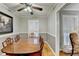 Dining room with a ceiling fan, hardwood floors, large window, and an elegant table at 2111 Jade Dr, Canton, GA 30115