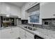 Bright kitchen featuring granite countertops, a stainless steel sink, and wood-look flooring at 2111 Jade Dr, Canton, GA 30115