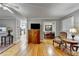 Open-concept living room showcasing hardwood floors, a TV, and a view into the adjacent dining area at 2111 Jade Dr, Canton, GA 30115