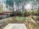 Shady backyard with a lush grassy lawn, mature trees, and a fenced perimeter at 3160 Sable Trl, Atlanta, GA 30349