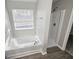 Bathroom featuring a window over a tub and a shower stall at 3160 Sable Trl, Atlanta, GA 30349