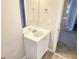 Bathroom vanity featuring a white countertop, mirror, and wood-look tile floors at 3160 Sable Trl, Atlanta, GA 30349