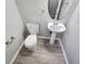 Well-lit half bathroom featuring a pedestal sink, toilet, and neutral decor at 3160 Sable Trl, Atlanta, GA 30349