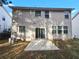 Back exterior of the house with siding, windows, sliding glass door, and a concrete patio at 3160 Sable Trl, Atlanta, GA 30349