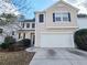 Charming two-story home featuring a two-car garage, black shutters, and a well-maintained driveway at 3160 Sable Trl, Atlanta, GA 30349