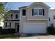 Two-story home with a large garage, neutral siding, and manicured landscaping at 3160 Sable Trl, Atlanta, GA 30349