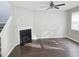 Bright living room with a modern fireplace, ceiling fan, and new flooring at 3160 Sable Trl, Atlanta, GA 30349