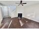 Bright living room featuring hardwood floors, fireplace, and a ceiling fan at 3160 Sable Trl, Atlanta, GA 30349