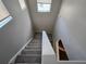 Carpeted staircase with neutral walls and natural light from a skylight at 3160 Sable Trl, Atlanta, GA 30349